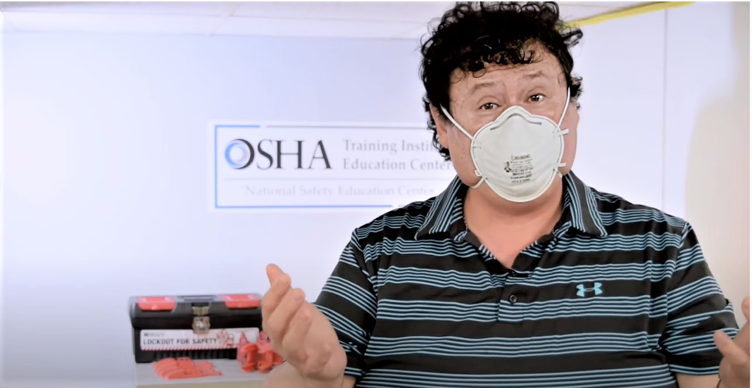Man showing how to put on a respirator mask